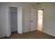 Bedroom features neutral carpet, closet with bi-fold doors, and archway to an adjacent room at 910 Amy Ridge Ct, Kissimmee, FL 34747