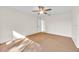 The primary bedroom offers neutral walls and carpet, ceiling fan, and an adjoining en-suite bath at 910 Amy Ridge Ct, Kissimmee, FL 34747