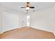 Bedroom features neutral walls, neutral carpeting, ceiling fan, and closet with double doors at 910 Amy Ridge Ct, Kissimmee, FL 34747