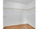 Walk-in closet offers metal shelving and carpeted floors in neutral tones at 910 Amy Ridge Ct, Kissimmee, FL 34747