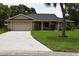 Charming single-story home features a well-manicured lawn and a two-car garage at 910 Amy Ridge Ct, Kissimmee, FL 34747