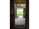 View through the doorway showing the front yard and exterior landscape of the home at 910 Amy Ridge Ct, Kissimmee, FL 34747