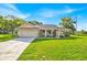 Charming single-story home with a well-manicured lawn and attached two-car garage at 910 Amy Ridge Ct, Kissimmee, FL 34747