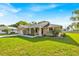 Well-maintained single-story home with lush green lawn and inviting landscaping at 910 Amy Ridge Ct, Kissimmee, FL 34747
