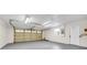 Spacious garage with ample lighting and a side door at 910 Amy Ridge Ct, Kissimmee, FL 34747