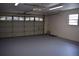 Clean garage interior with a gray floor, featuring a window and an automatic garage door at 910 Amy Ridge Ct, Kissimmee, FL 34747