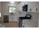 Renovated kitchen featuring white cabinetry, stainless steel appliances, and modern countertops at 910 Amy Ridge Ct, Kissimmee, FL 34747