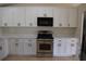 Bright kitchen features white cabinets, modern appliances and neutral countertops at 910 Amy Ridge Ct, Kissimmee, FL 34747