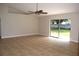 Spacious living room with tile flooring, ceiling fan, and sliding glass doors to the backyard at 910 Amy Ridge Ct, Kissimmee, FL 34747