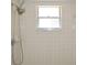 A tiled shower features a showerhead and a window at 910 Amy Ridge Ct, Kissimmee, FL 34747