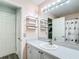 Well-lit bathroom featuring a vanity, large mirror, and a decorative shower curtain at 9376 Se 175Th Pompion St, The Villages, FL 32162