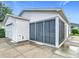 Exterior view features a home with a screened-in lanai and a detached garage at 9376 Se 175Th Pompion St, The Villages, FL 32162