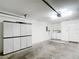 Spacious garage equipped with washer, dryer, storage cabinets, and ample room for parking at 9376 Se 175Th Pompion St, The Villages, FL 32162