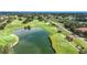 Scenic aerial view of a lush golf course featuring a tranquil pond and well-manicured greens at 9376 Se 175Th Pompion St, The Villages, FL 32162