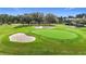 Scenic golf course featuring lush green grass, mature trees and challenging sand traps for golf enthusiasts at 9376 Se 175Th Pompion St, The Villages, FL 32162
