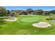 Lush golf course featuring manicured green and strategically placed sand traps providing a challenging yet picturesque landscape at 9376 Se 175Th Pompion St, The Villages, FL 32162