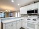 Bright kitchen showcases white cabinets, modern appliances, and a convenient breakfast bar area at 9376 Se 175Th Pompion St, The Villages, FL 32162