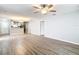 Open concept living room featuring luxury vinyl plank flooring, eat-in kitchen, and modern ceiling fan at 9376 Se 175Th Pompion St, The Villages, FL 32162