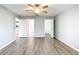 Spacious main bedroom boasts wood-look floors, neutral walls, and multiple doorways to adjacent rooms and closet at 9376 Se 175Th Pompion St, The Villages, FL 32162