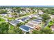 Aerial view of a well-maintained neighborhood showcasing manicured lawns, mature trees, and a serene atmosphere at 9376 Se 175Th Pompion St, The Villages, FL 32162