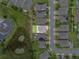 Aerial view displays the home's position in a neighborhood with adjacent pond at 944 Benjamin Trl, Davenport, FL 33837