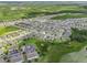 Wide aerial shot showcasing the property within a sprawling residential community at 944 Benjamin Trl, Davenport, FL 33837