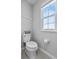 Bright bathroom with window and neutral finishes and toilet at 944 Benjamin Trl, Davenport, FL 33837