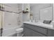 A full bathroom with a gray vanity and shower and tub combo at 944 Benjamin Trl, Davenport, FL 33837