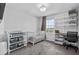 Bright bedroom featuring a crib, changing table, and workspace at 944 Benjamin Trl, Davenport, FL 33837