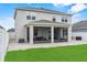 Rear exterior view highlights the covered screened-in patio that walks out to the backyard at 944 Benjamin Trl, Davenport, FL 33837
