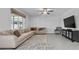 Comfortable living room with neutral tones, a large sofa, and a mounted TV at 944 Benjamin Trl, Davenport, FL 33837