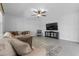 A living room featuring a large sofa and a mounted TV at 944 Benjamin Trl, Davenport, FL 33837