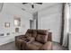 Comfortable living room featuring reclining love seat, shelving and window at 944 Benjamin Trl, Davenport, FL 33837