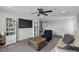 Spacious loft featuring a ceiling fan, sofa, chair and a large bookshelf at 944 Benjamin Trl, Davenport, FL 33837