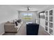 Comfortable loft with sofa, chair, TV, and bright natural light at 944 Benjamin Trl, Davenport, FL 33837