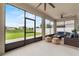 Inviting screened patio features stylish outdoor furniture, ceiling fans, and views of the backyard at 944 Benjamin Trl, Davenport, FL 33837