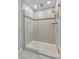 Glass enclosed shower featuring tile walls, and a shower head at 944 Benjamin Trl, Davenport, FL 33837