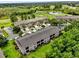 Aerial view of townhomes, golf course and lakes, showcasing community's layout and green spaces at 9440 Myrtle Creek Ln # 1003, Orlando, FL 32832