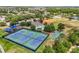 Aerial view of community amenities including tennis courts, basketball court, pool, and clubhouse at 9440 Myrtle Creek Ln # 1003, Orlando, FL 32832