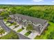 Aerial view of townhomes with well-manicured lawns, mature trees, and ample parking spaces at 9440 Myrtle Creek Ln # 1003, Orlando, FL 32832