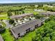 Aerial view of condo community and golf course with lake in background at 9440 Myrtle Creek Ln # 1003, Orlando, FL 32832