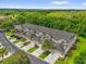 Aerial view of a well-maintained community with lush landscaping, palm trees, and paved roads at 9440 Myrtle Creek Ln # 1003, Orlando, FL 32832