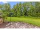 Brick-paved patio with view of lush green backyard and a bird feeder at 9440 Myrtle Creek Ln # 1003, Orlando, FL 32832