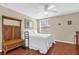 Comfortable bedroom with a ceiling fan, natural lighting, and wood floors at 9440 Myrtle Creek Ln # 1003, Orlando, FL 32832