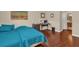Bedroom showcasing hardwood floors, modern furnishings, and an en-suite bathroom at 9440 Myrtle Creek Ln # 1003, Orlando, FL 32832