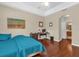 Comfortable bedroom with hardwood floors, neutral walls, and a ceiling fan for ventilation at 9440 Myrtle Creek Ln # 1003, Orlando, FL 32832