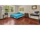 Bedroom boasting hardwood floors, natural light, and a dedicated workspace at 9440 Myrtle Creek Ln # 1003, Orlando, FL 32832