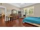 Spacious bedroom with hardwood floors, natural light, and an adjacent living area at 9440 Myrtle Creek Ln # 1003, Orlando, FL 32832