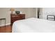 Cozy bedroom featuring hardwood floors, dresser, and neutral paint at 9440 Myrtle Creek Ln # 1003, Orlando, FL 32832
