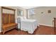 Bright bedroom with hardwood floors, a window, and a wicker-accented hall tree at 9440 Myrtle Creek Ln # 1003, Orlando, FL 32832